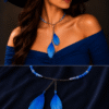 Woman wearing blue feather choker necklace set with stylish modern fashion look and wide hat closeup