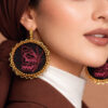 pink handmde statemenr earrings closeup