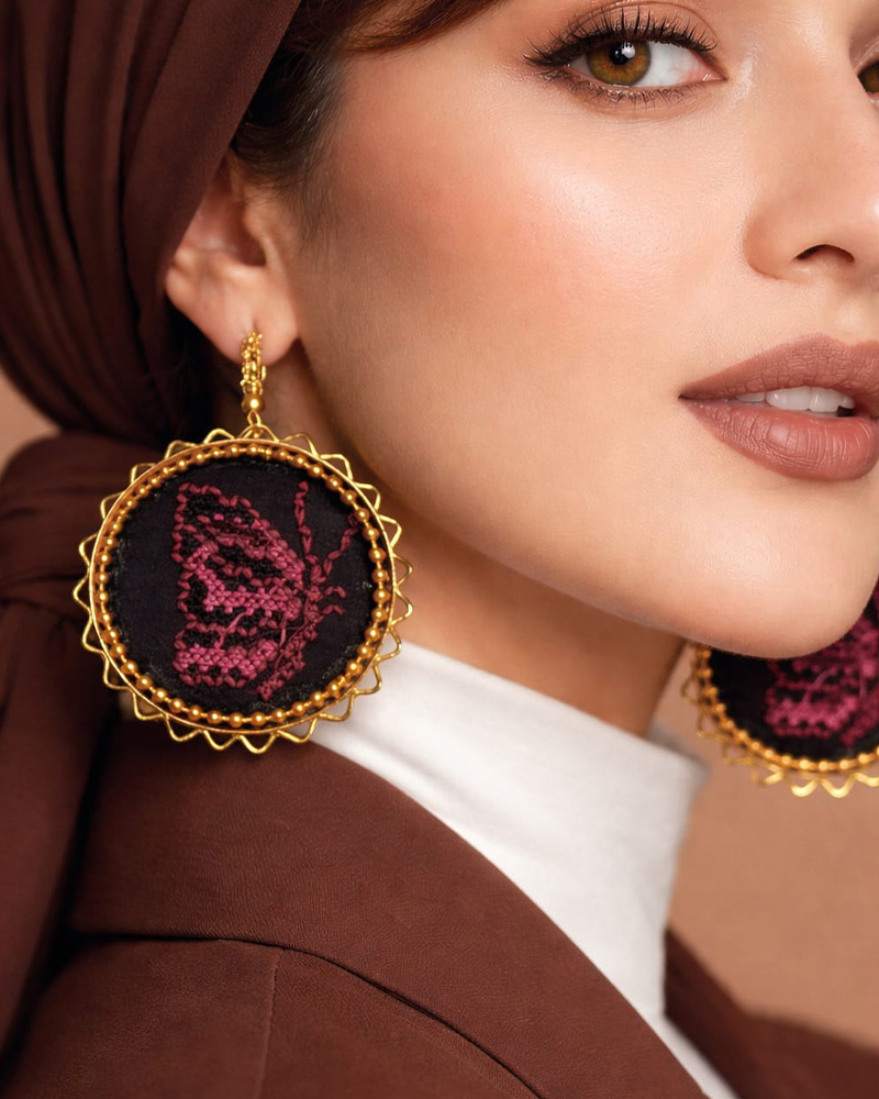 pink handmde statemenr earrings closeup