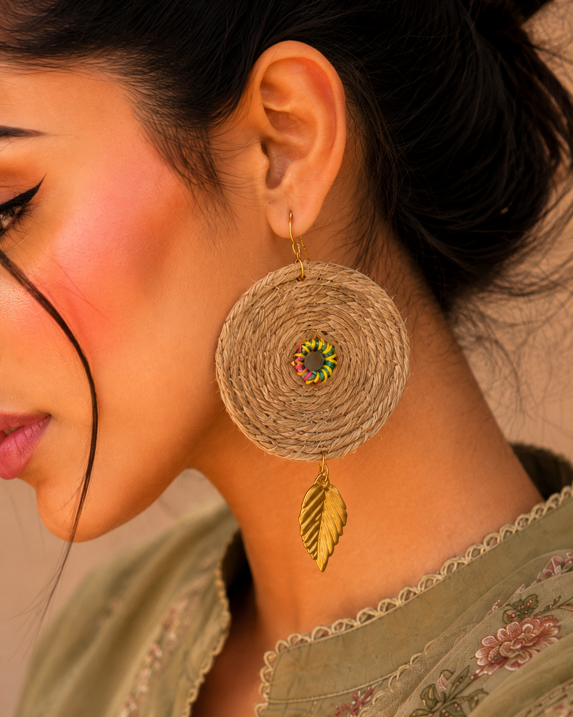 Handmade boho jute earrings with gold leaf charm closeup