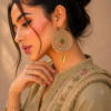 Handmade boho jute earrings with gold leaf charm side view