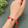 Handmade pink charm bracelet with gold chain and decorative charms