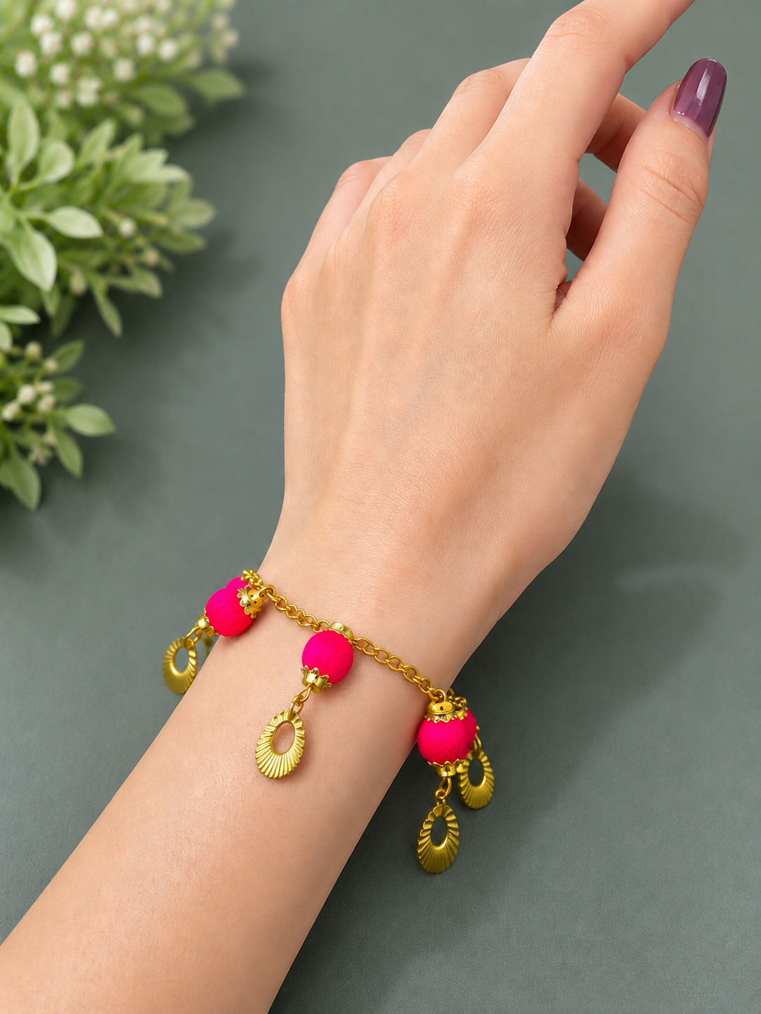 Handmade pink charm bracelet with gold chain and decorative charms