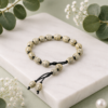 Handmade beige adjustable beaded bracelet with premium patterned beads for women.