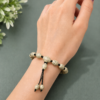 Handmade beige adjustable beaded bracelet with premium patterned beads for women.