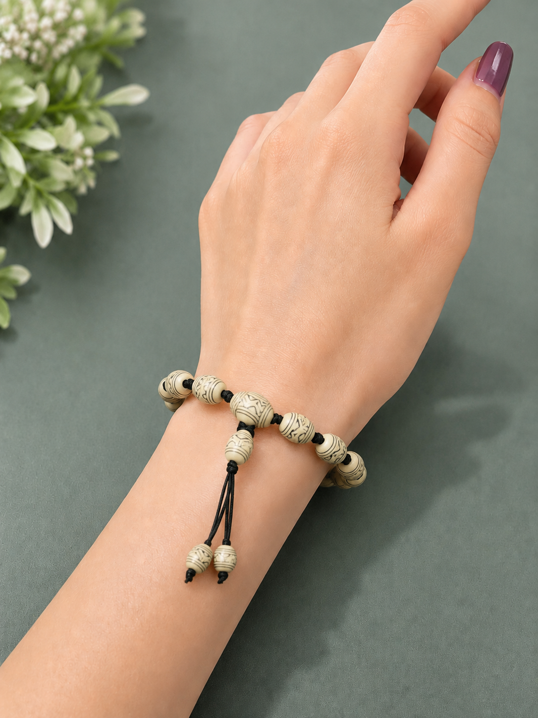 Handmade beige adjustable beaded bracelet with premium patterned beads for women.