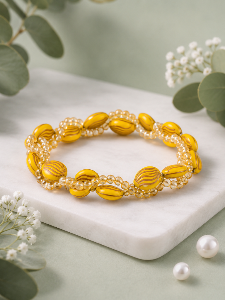 Handmade yellow beaded bracelet with crystal accents.