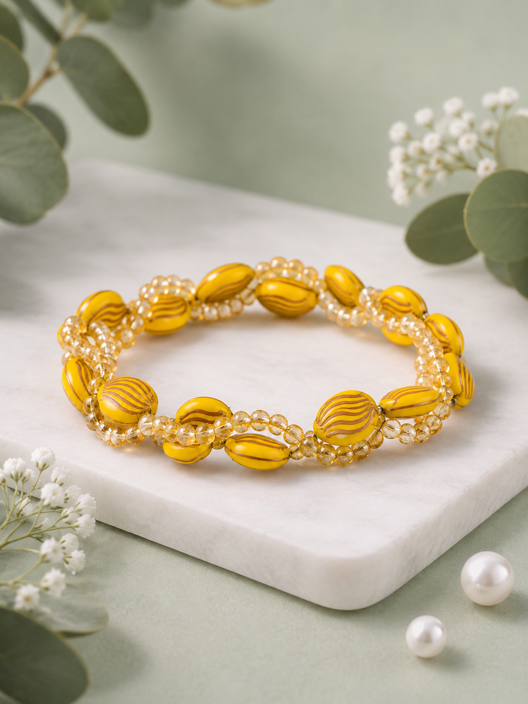 Handmade yellow beaded bracelet with crystal accents.