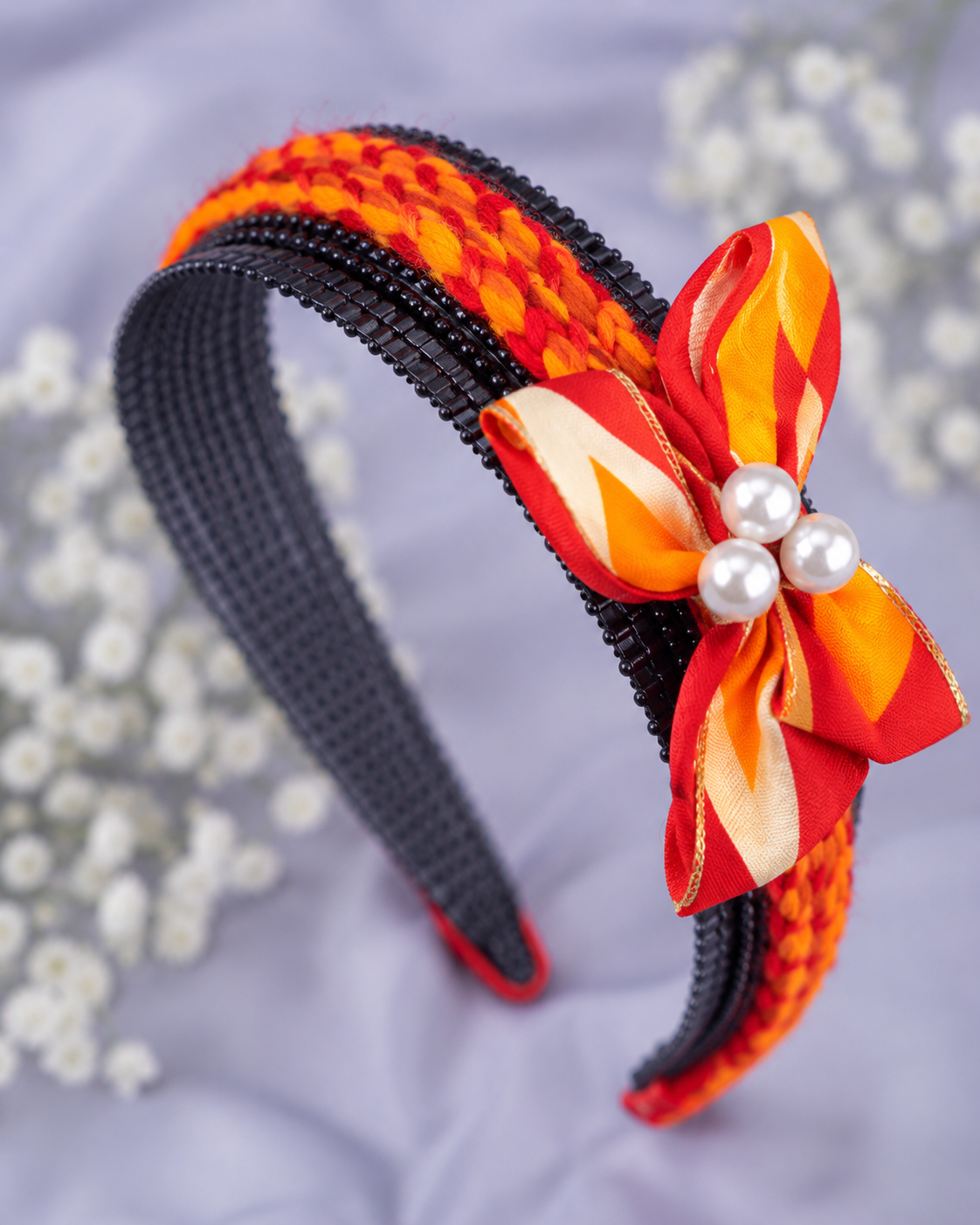 Handmade red and orange braided hair band with ribbon bow and pearl embellishments for women and girls by GALORIA, perfect for casual, party and festive wear.